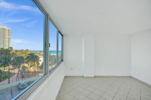 tiled empty room with a water view