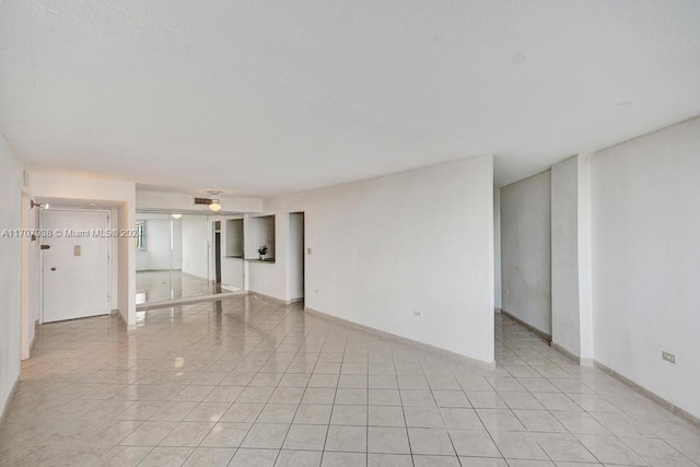 empty room with light tile patterned flooring