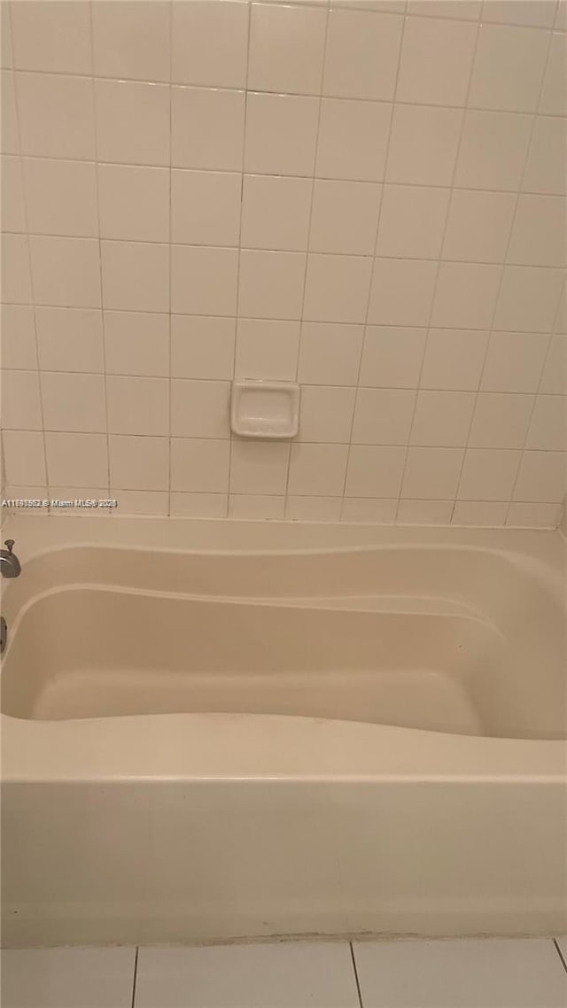 bathroom featuring tile patterned floors and  shower combination