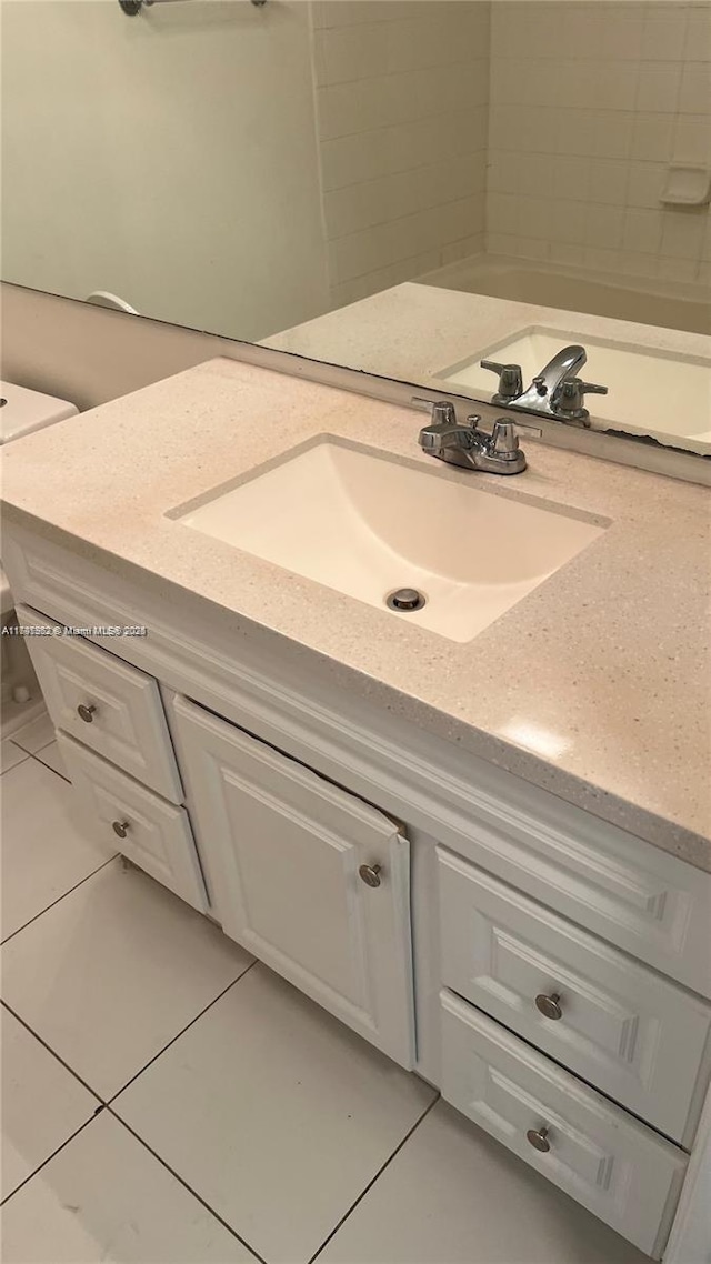 bathroom with tile patterned flooring and vanity