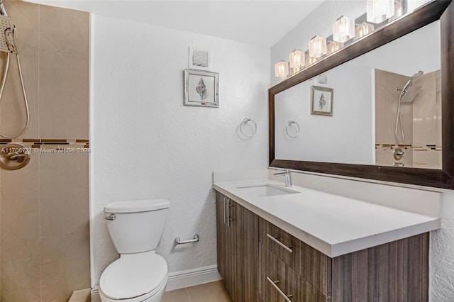 bathroom with tile patterned flooring, a shower, vanity, and toilet