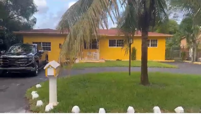 ranch-style house with a front lawn