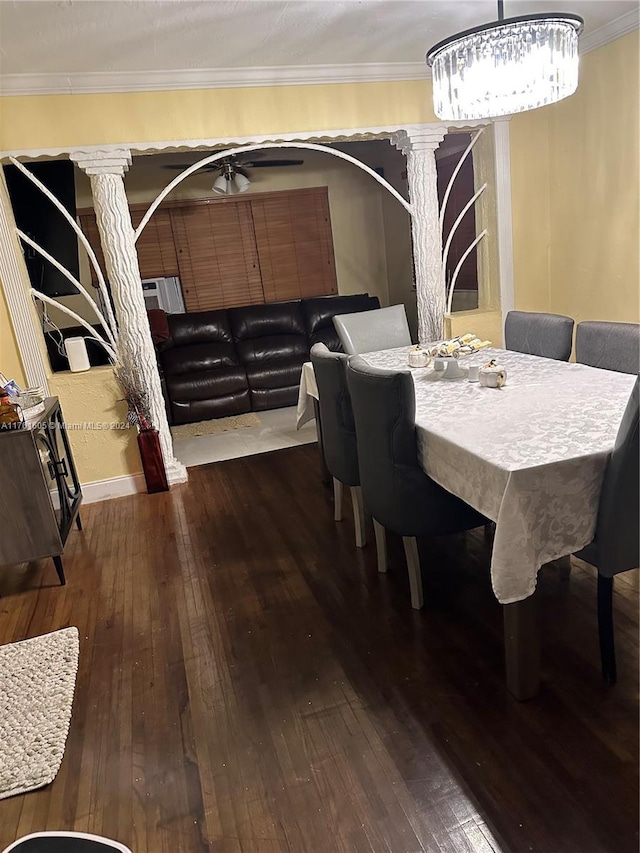 dining room featuring hardwood / wood-style flooring, ornate columns, ceiling fan, and ornamental molding