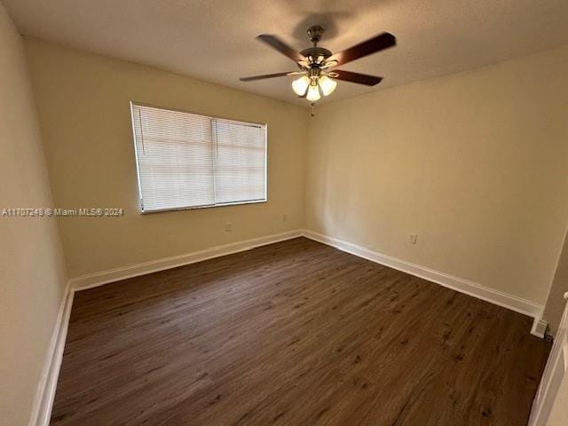 unfurnished room with ceiling fan and dark hardwood / wood-style floors