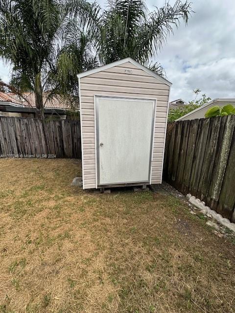 view of outbuilding with a yard