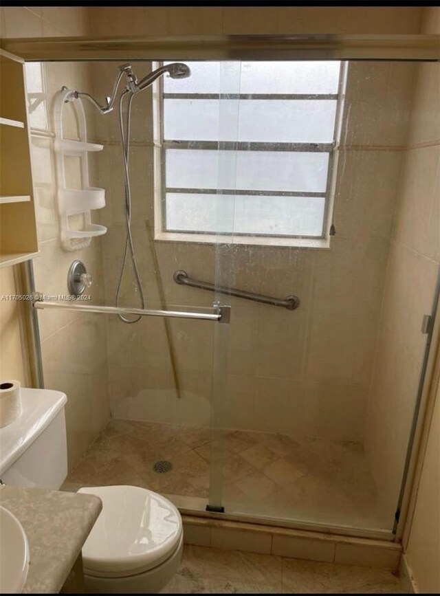 4575 Gladiator Cir, Green Acres, FL 33463 - bathroom with toilet, a stall shower, and vanity