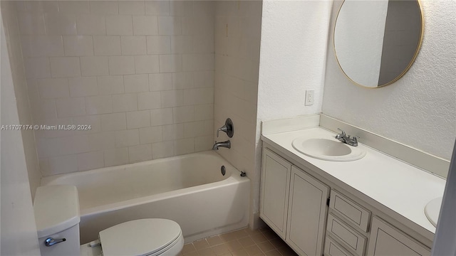 full bathroom with tile patterned floors, vanity, toilet, and tiled shower / bath combo