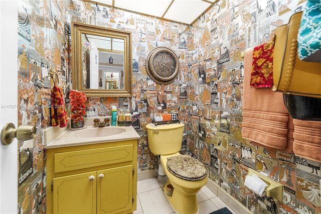 bathroom with tile patterned flooring, vanity, and toilet