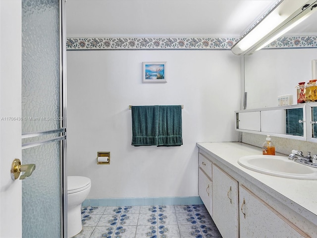 bathroom with tile patterned floors, vanity, and toilet