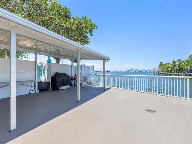 view of patio / terrace featuring a water view and a grill