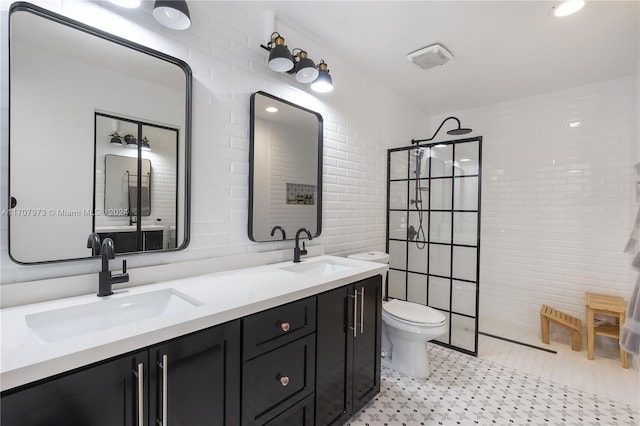 bathroom featuring a tile shower, vanity, toilet, and tile walls