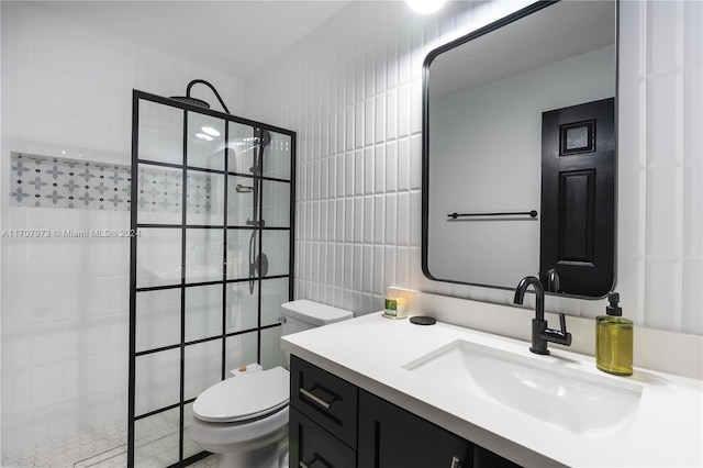 bathroom featuring tiled shower, vanity, tile walls, and toilet