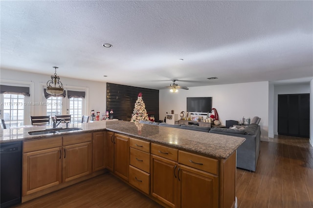 kitchen with ceiling fan, dishwasher, sink, dark hardwood / wood-style flooring, and a textured ceiling