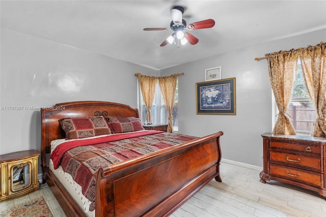 bedroom with ceiling fan and light hardwood / wood-style flooring