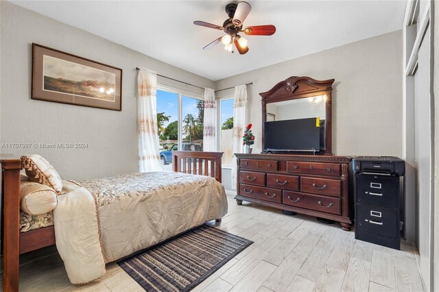 bedroom with light hardwood / wood-style floors and ceiling fan