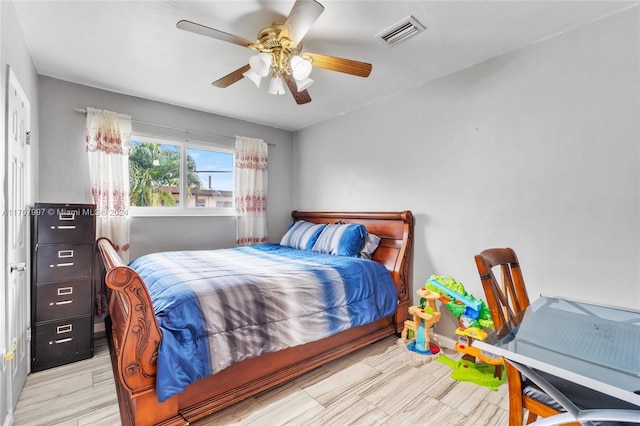 bedroom with ceiling fan and light wood-type flooring