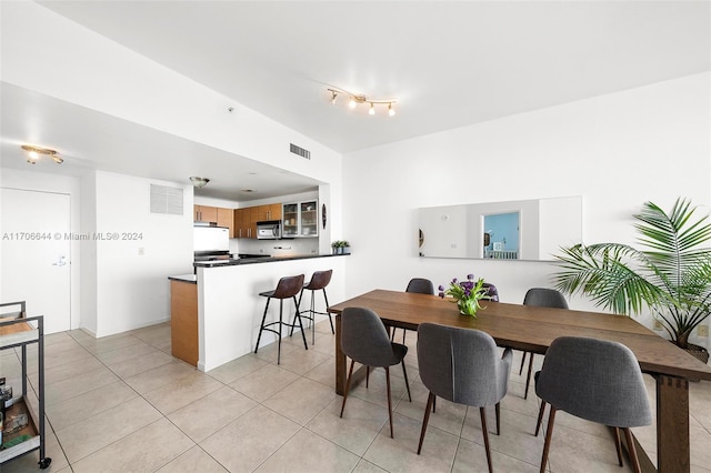 dining space with light tile patterned floors