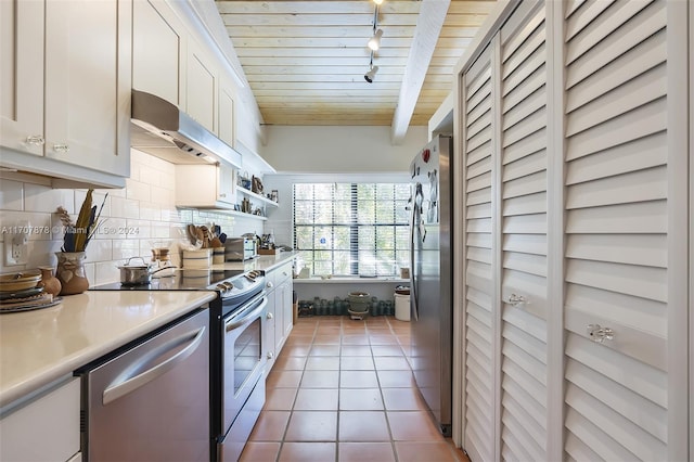 kitchen featuring decorative backsplash, appliances with stainless steel finishes, beam ceiling, tile patterned flooring, and white cabinetry