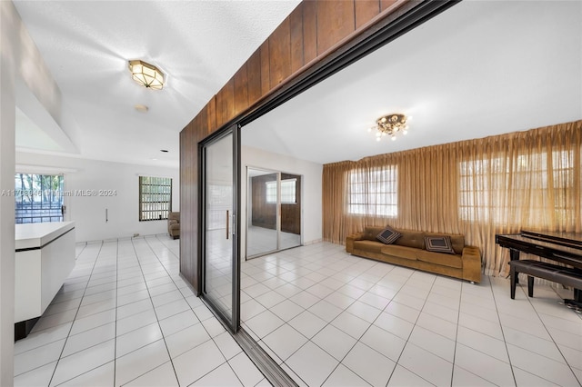 tiled living room featuring wooden walls