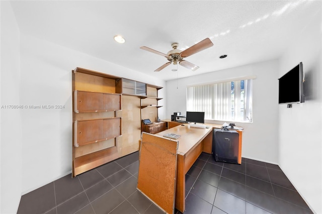 tiled home office featuring ceiling fan