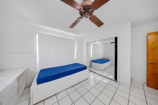 tiled bedroom featuring a closet and ceiling fan