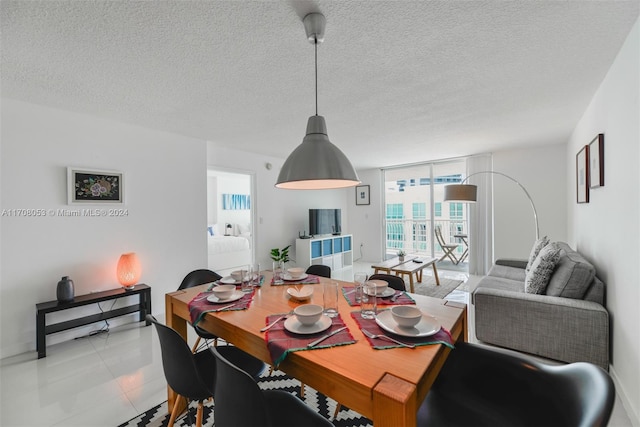 tiled dining room with a textured ceiling