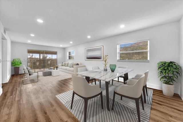 dining space with hardwood / wood-style floors