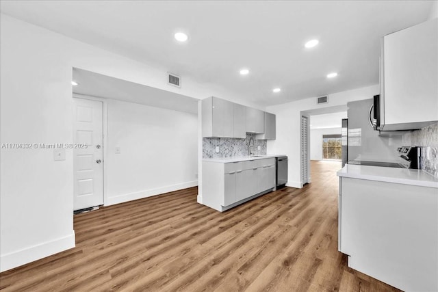 1200 SW 130th Ave Unit 412G, Pembroke Pines, FL 33027 - kitchen with stainless steel appliances, baseboards, light countertops, recessed lighting, and decorative backsplash