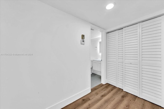 hallway with wood-type flooring