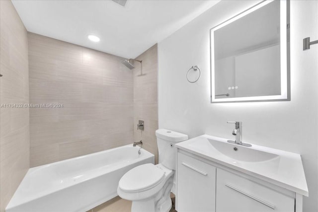 full bathroom featuring vanity, toilet, and tiled shower / bath