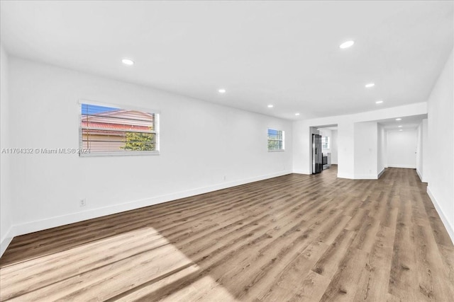 unfurnished living room with a healthy amount of sunlight and light wood-type flooring