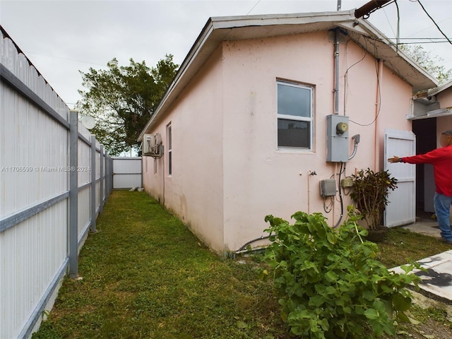 view of side of property with a yard