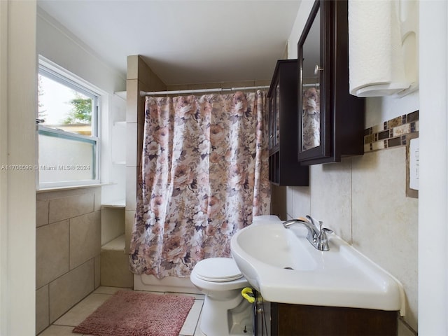 full bathroom with toilet, vanity, tile patterned floors, and tile walls