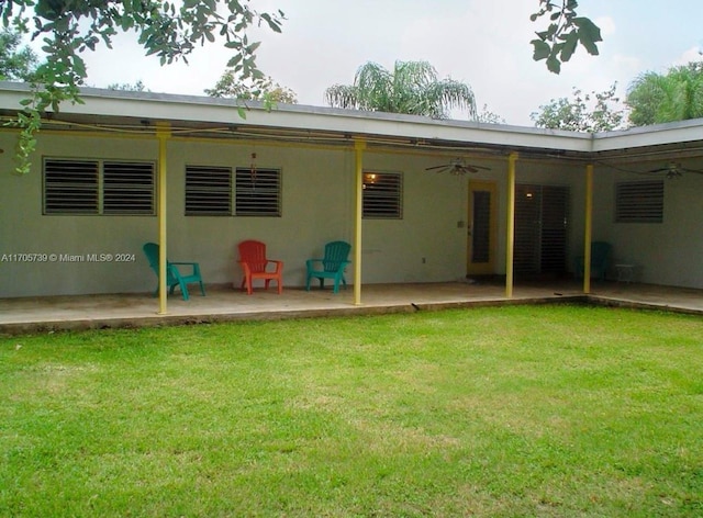 rear view of property with a lawn, ceiling fan, and a patio area