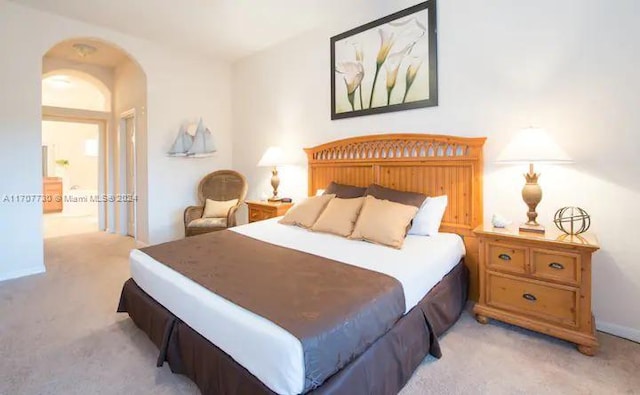 carpeted bedroom featuring connected bathroom