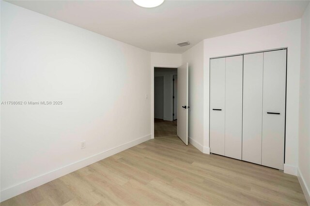 unfurnished room with light wood-type flooring