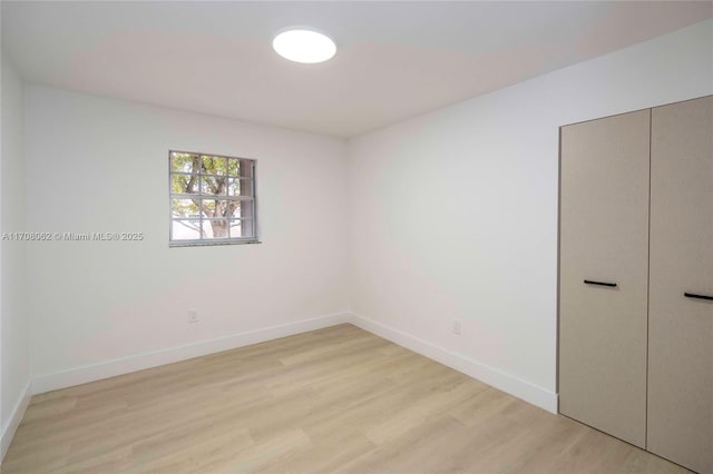 empty room with light hardwood / wood-style flooring