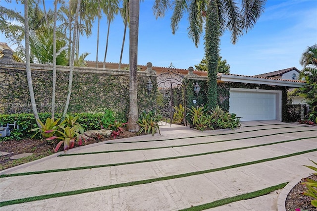 1960 NE 118th Rd, North Miami, FL 33181 - view of front of home with a tiled roof, a garage, driveway, and stucco siding