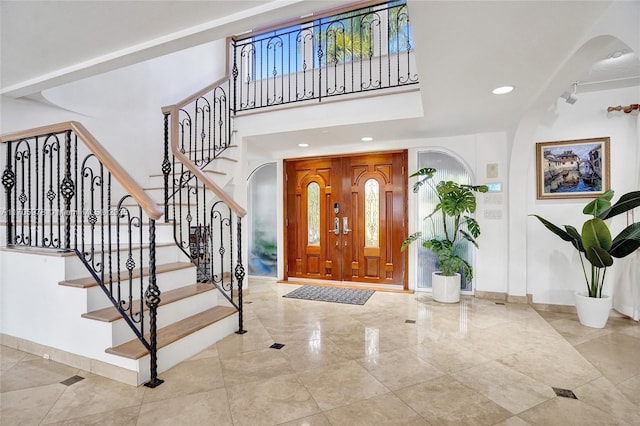 1960 NE 118th Rd, North Miami, FL 33181 - entryway featuring arched walkways, baseboards, stairs, recessed lighting, and a towering ceiling