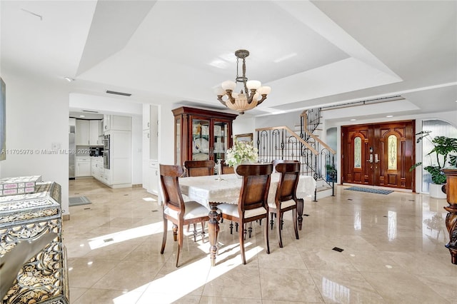 1960 NE 118th Rd, North Miami, FL 33181 - dining room featuring a chandelier, a tray ceiling, stairway, and light tile patterned floors
