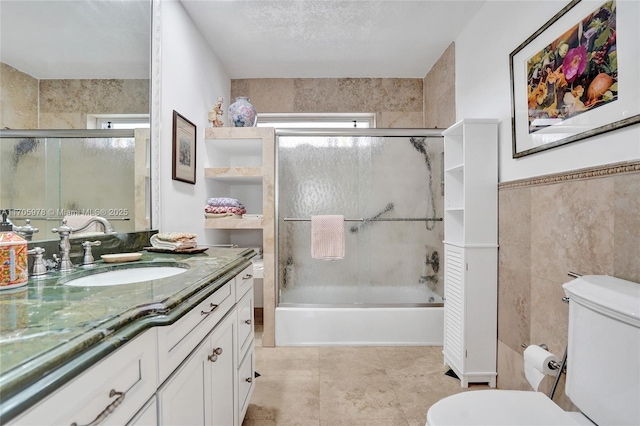 1960 NE 118th Rd, North Miami, FL 33181 - full bath featuring plenty of natural light, vanity, toilet, combined bath / shower with glass door, and tile walls