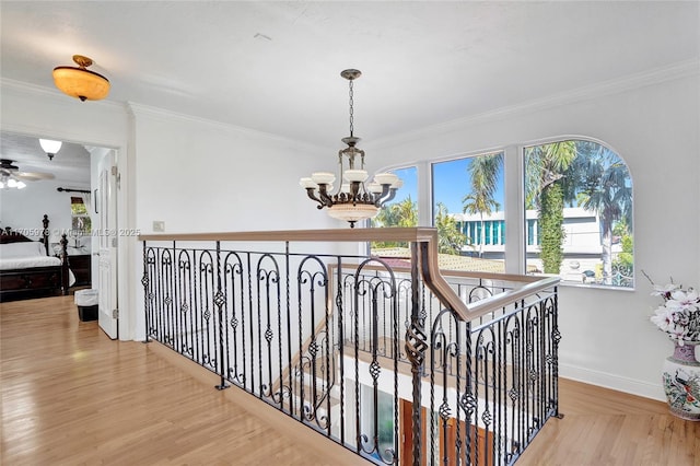 1960 NE 118th Rd, North Miami, FL 33181 - hall with a chandelier, ornamental molding, baseboards, wood finished floors, and an upstairs landing