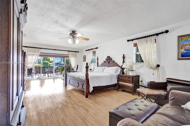 bedroom with ceiling fan, access to exterior, light wood-type flooring, and a textured ceiling