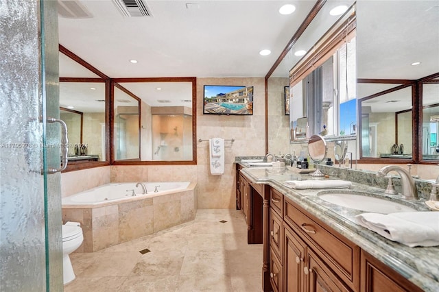 bathroom featuring tiled tub, vanity, ornamental molding, and toilet