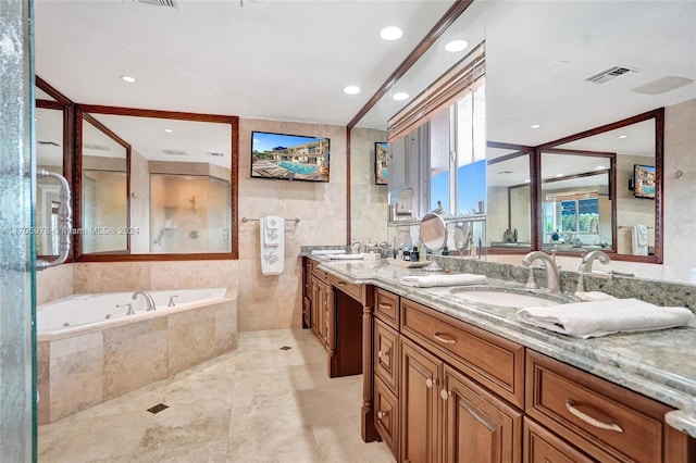 bathroom featuring tiled tub and vanity