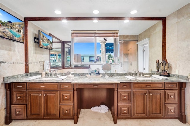 bathroom featuring vanity and tile walls