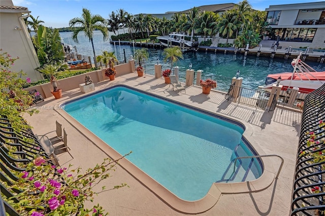 view of swimming pool featuring a water view and a patio