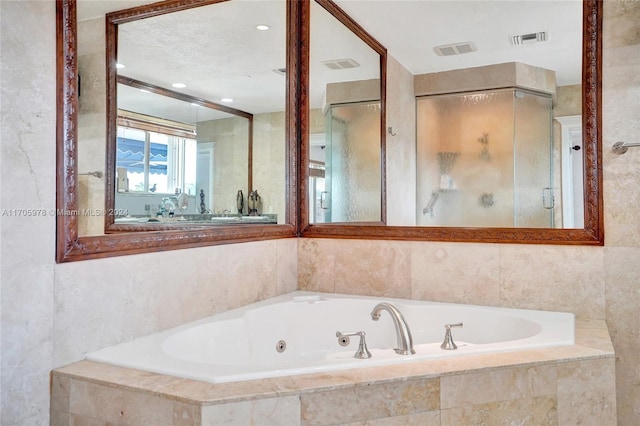 bathroom featuring shower with separate bathtub