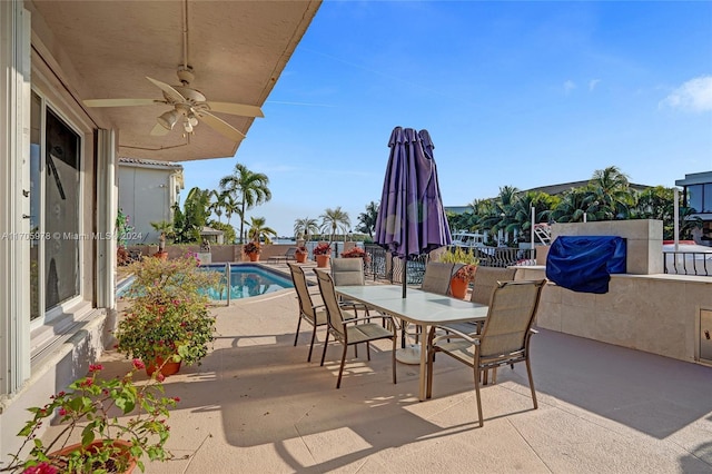 view of patio with a fenced in pool and ceiling fan