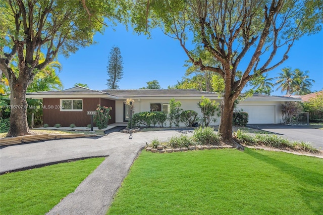 ranch-style house with a front yard and a garage